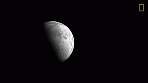 A Black And White Photo Of A Crescent Moon In The Night Sky GIF