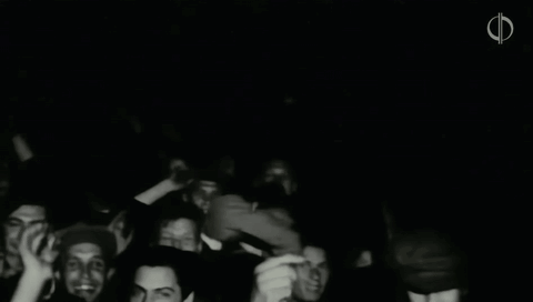 A Black And White Photo Of A Crowd Of People With The Letter F In The Upper Right Corner GIF