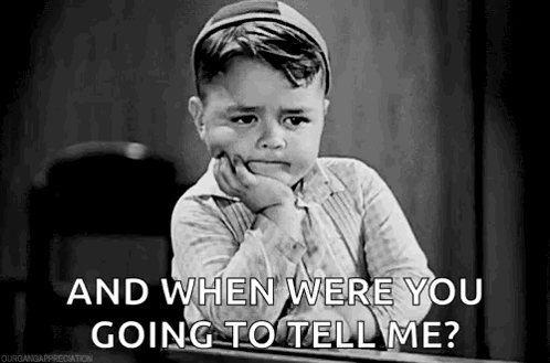 A Black And White Photo Of A Crying Boy Sitting At A Desk . GIF