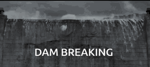 A Black And White Photo Of A Dam With The Words " Dam Breaking " Below It GIF