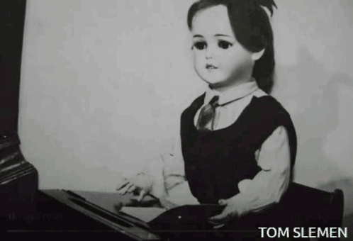 A Black And White Photo Of A Doll With The Name Tom Slemen Underneath It GIF