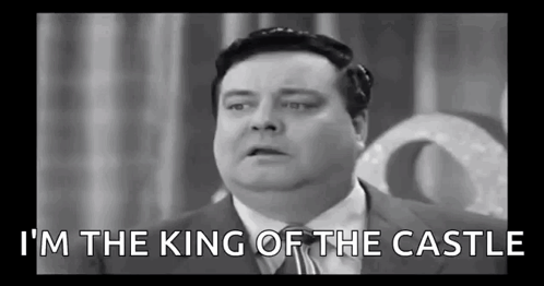 A Black And White Photo Of A Fat Man In A Suit And Tie Talking . GIF