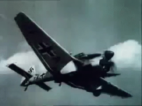 A Black And White Photo Of A Fighter Jet Flying Through The Sky . GIF