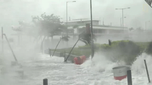 A Black And White Photo Of A Flooded Area With A Sign That Says ' N ' On It GIF