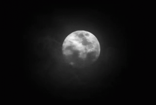A Black And White Photo Of A Full Moon In The Night Sky GIF