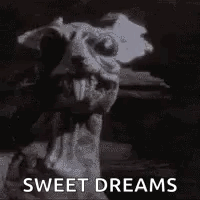 A Black And White Photo Of A Gargoyle With The Words `` Sweet Dreams '' Written Next To It . GIF