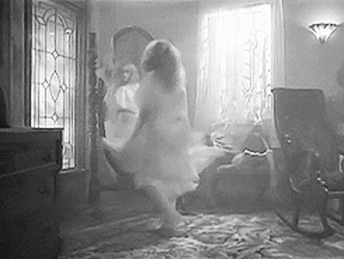 A Black And White Photo Of A Ghost Dancing In A Living Room . GIF