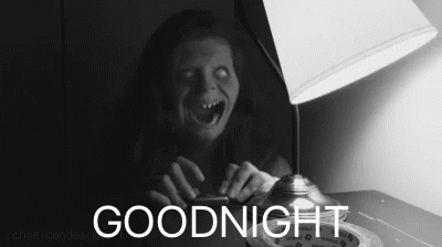 A Black And White Photo Of A Ghost Sitting Next To A Lamp With The Words Goodnight Below It GIF