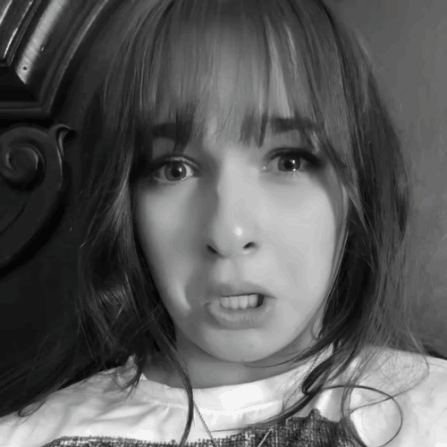 A Black And White Photo Of A Girl Making A Face GIF