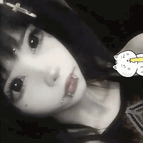 A Black And White Photo Of A Girl With Piercings In Her Lips GIF