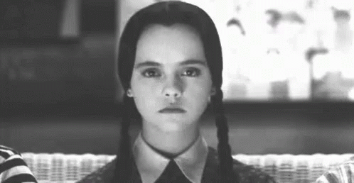 A Black And White Photo Of A Girl With Pigtails Making A Face . GIF