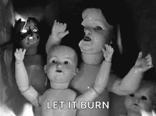 A Black And White Photo Of A Group Of Dolls With The Words Let It Burn Below Them GIF