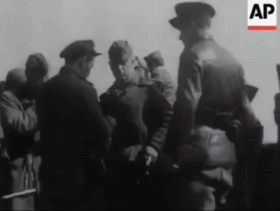 A Black And White Photo Of A Group Of Men Standing Next To Each Other With The Letters Ap In The Corner . GIF