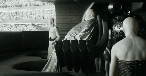 A Black And White Photo Of A Group Of People Including A Woman GIF