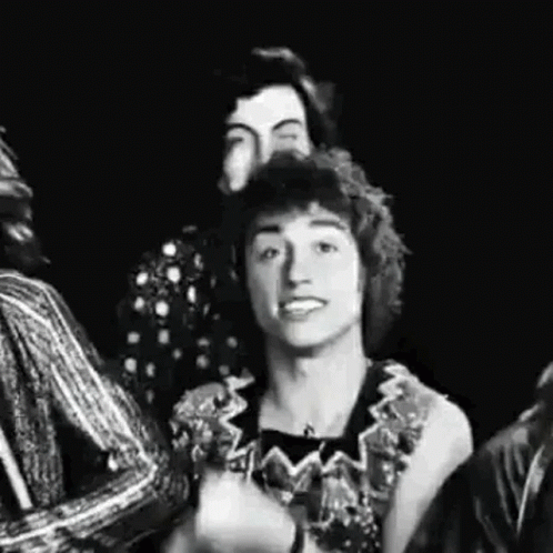 A Black And White Photo Of A Group Of People Standing Next To Each Other And Smiling . GIF