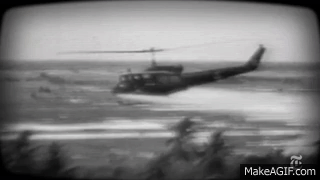 A Black And White Photo Of A Helicopter Flying Over A Body Of Water With Makeagif.com At The Bottom GIF