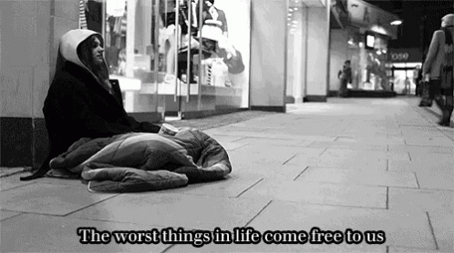 A Black And White Photo Of A Homeless Person With The Words " The Worst Things In Life Come Free To Us " Above Them GIF
