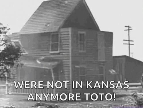 A Black And White Photo Of A House With The Words " We 'Re Not In Kansas Anymore Toto " GIF