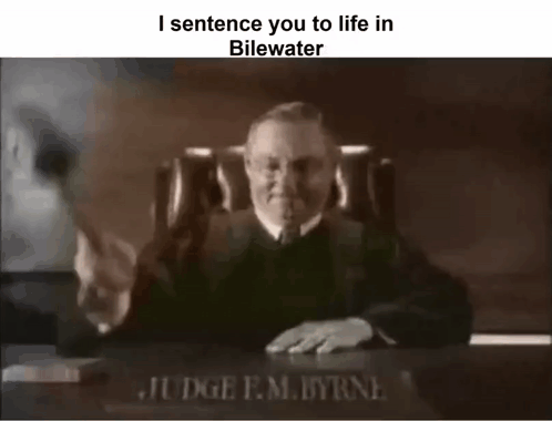 A Black And White Photo Of A Judge Sitting At A Desk With A Gavel In Front Of Him . GIF
