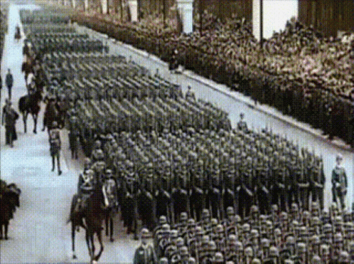 A Black And White Photo Of A Large Military Parade GIF