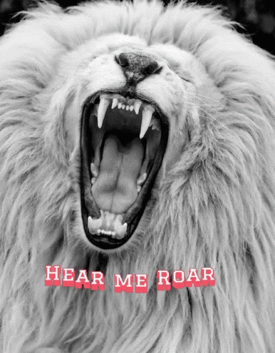 A Black And White Photo Of A Lion With Its Mouth Open And The Words Hear Me Roar Below It GIF