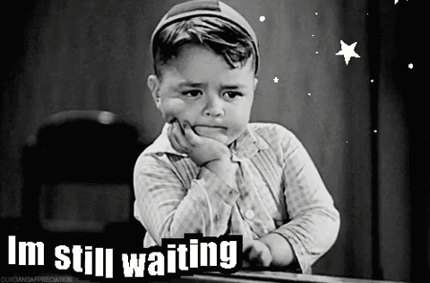 a black and white photo of a little boy with the words i 'm still waiting on the bottom