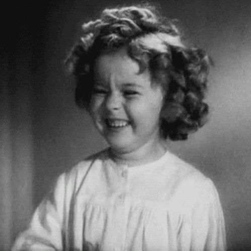 A Black And White Photo Of A Little Girl Laughing . GIF
