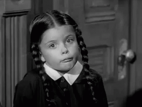 A Black And White Photo Of A Little Girl Making A Funny Face . GIF