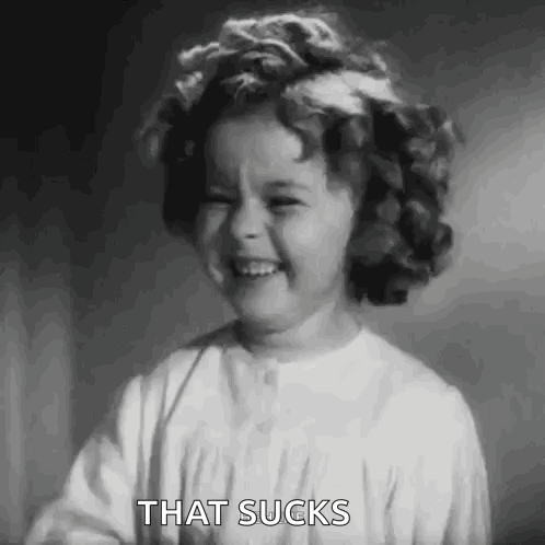 A Black And White Photo Of A Little Girl With A Flower In Her Hair . GIF