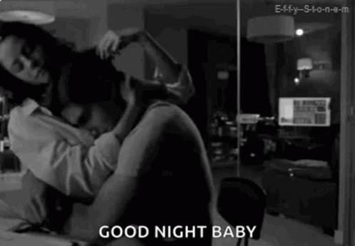 A Black And White Photo Of A Man And A Woman Hugging Each Other . GIF