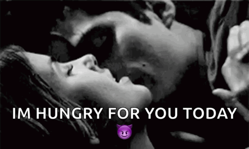 A Black And White Photo Of A Man And A Woman Kissing . GIF
