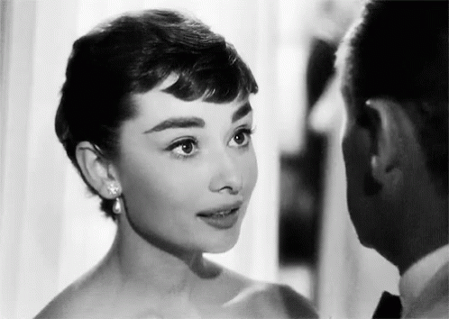 Black And White Photo Of Man And Woman Looking At Each Other GIF