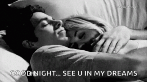 A Black And White Photo Of A Man And A Woman Sleeping In A Bed . GIF