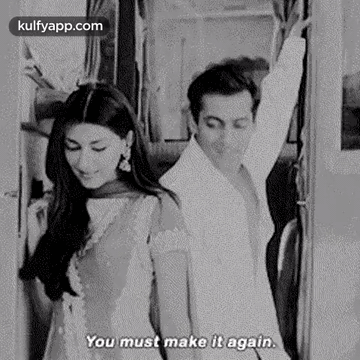 A Black And White Photo Of A Man And A Woman Standing Next To Each Other On A Train . GIF