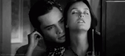 A Black And White Photo Of A Man And A Woman Talking On A Phone . GIF