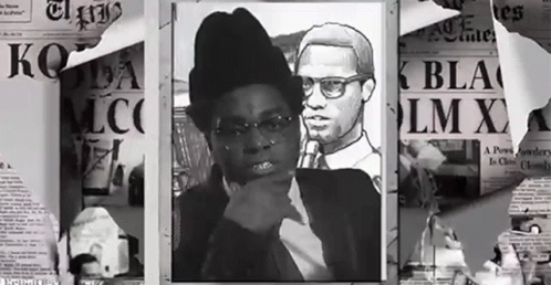 A Black And White Photo Of A Man And A Woman With A Newspaper That Says Lm X GIF