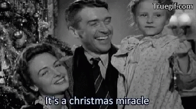 A Black And White Photo Of A Man And Woman Holding A Child . GIF
