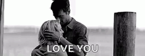a black and white photo of a man and woman hugging each other and the words `` love you '' .