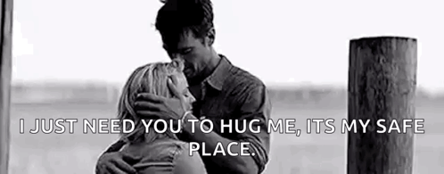A Black And White Photo Of A Man And Woman Hugging Each Other . GIF