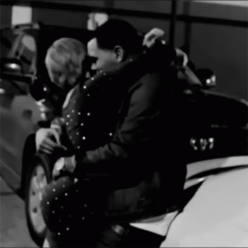 A Black And White Photo Of A Man And Woman Hugging GIF