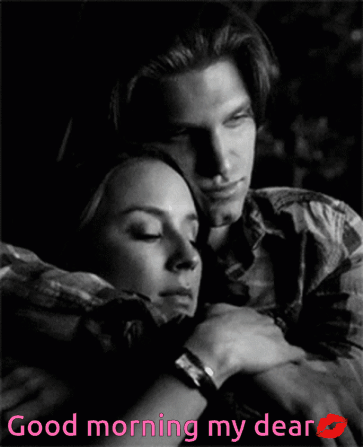 a black and white photo of a man and woman hugging with the words " good morning my dear "