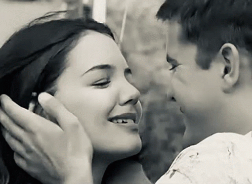 A Black And White Photo Of A Man And Woman Kissing . GIF