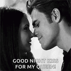 A Black And White Photo Of A Man And Woman Kissing Each Other . GIF