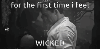 A Black And White Photo Of A Man And Woman Kissing With The Words For The First Time I Feel Wicked GIF