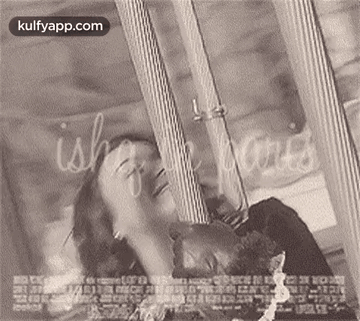 A Black And White Photo Of A Man And Woman Laying Next To Each Other On A Bed . GIF