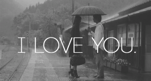 A Black And White Photo Of A Man And Woman Under An Umbrella With The Words I Love You GIF
