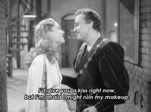 A Black And White Photo Of A Man And Woman With A Caption That Says " I 'D Give You A Kiss Right Now GIF
