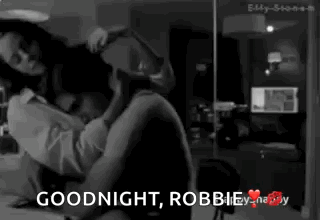 A Black And White Photo Of A Man And Woman With The Words Goodnight Robbie GIF
