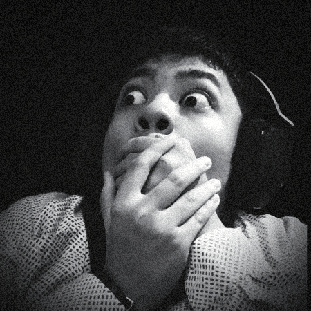 A Black And White Photo Of A Man Covering His Mouth GIF