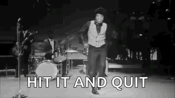 A Black And White Photo Of A Man Dancing On A Stage In Front Of A Microphone . GIF